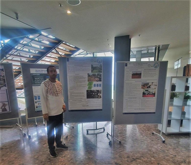 A man standin in front of a poster presentation.
